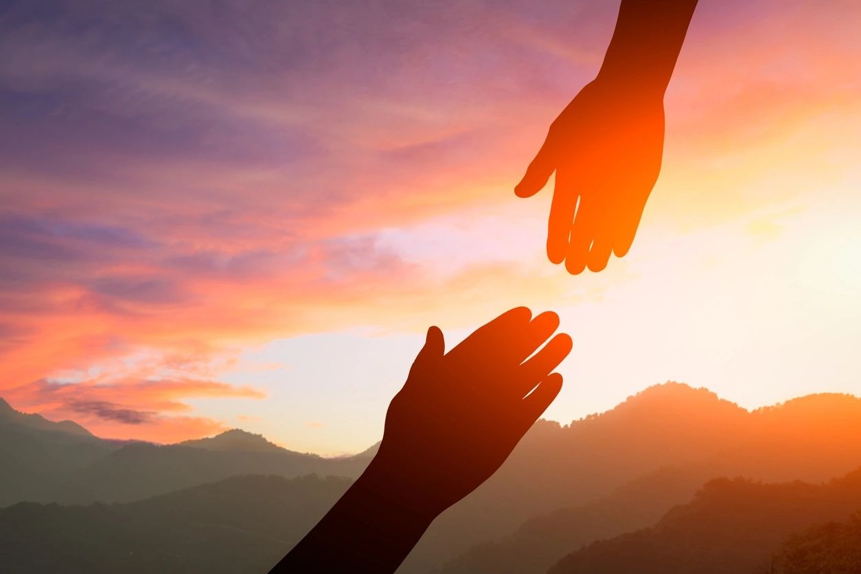 Helping hand with the sky sunset background