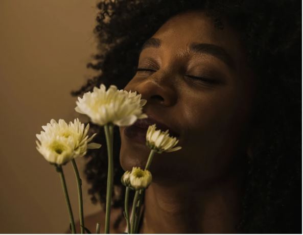 woman smelling flowers